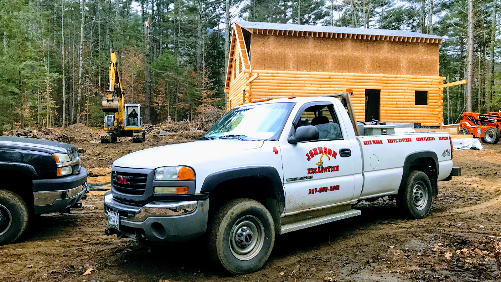Johnson Excavation truck at a wooded job site